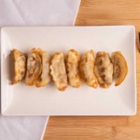 Gyoza · Pork dumplings stuffed with mixed vegetables and served with ginger soy sauce.