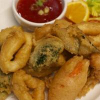 Crispy Thai Calamari · Calamari cooked tempura style served with Thai chili garlic dipping sauce.