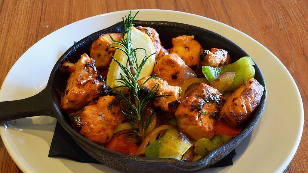 Chicken Tikka · Marinated in yogurt, ginger, garlic, tandoori spices, and served over onions and peppers