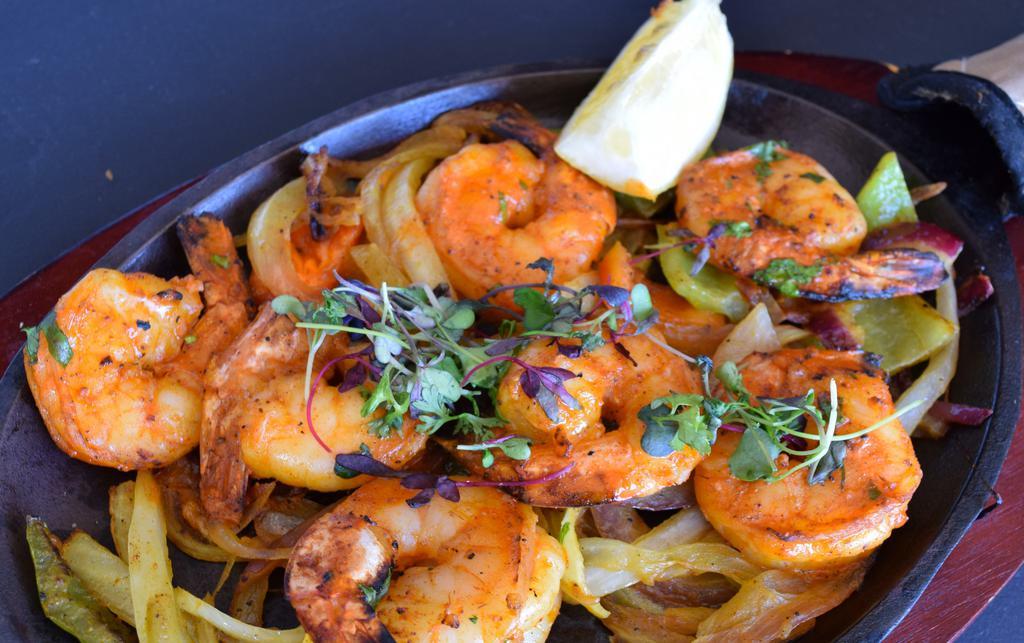 Shrimp Tikka · Marinated in yogurt, ginger, garlic, tandoori spices, and served over onions and peppers