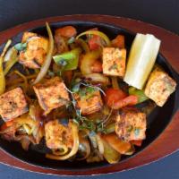 Paneer Tikka · Marinated in yogurt, ginger, garlic, tandoori spices, and served over onions and peppers