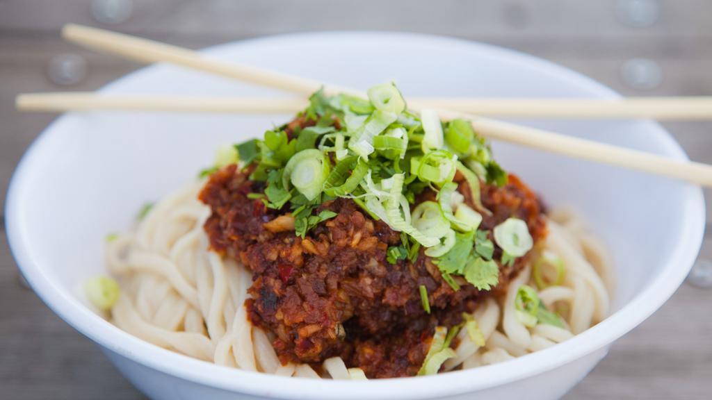 Spicy Garlic Peanut Noodles · Wok-toasted peanuts & garlic, our house chili oil, & hints of sesame & soy. Served warm over our noodles with a generous helping of super fresh cilantro.