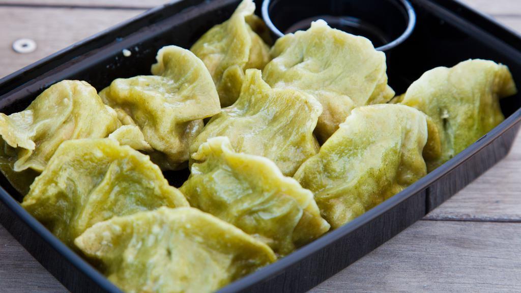 Edamame Dumplings · (10 count).Savory, decadent, & hot to be missed. Filled with a light yet substantial mixture of tender green edamame, puffy fried tofu, & savory tomatoes, these dumplings ensure that vegetarians are never an afterthought at MKNC.