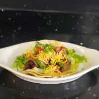 Steak Tacos · Served in a soft tortilla shell with lettuce, pico de gallo, and cheese.