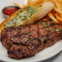 Exp Kc Strip And Fries · 12oz angus woodfire grilled KC strip, herb garlic butter, fries, grilled garlic bread