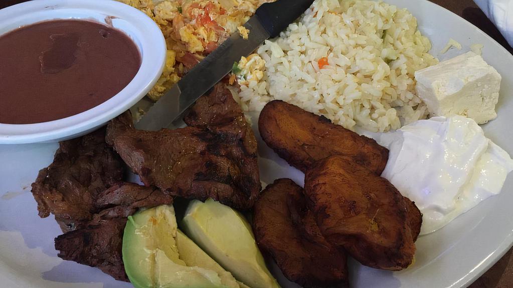Plato Paisano · Served with steak, Salvadorian-style scrambled eggs prepared with onions, green peppers, and tomatoes, rice, beans, fried plantains, avocado, Salvadorian cheese, and sour cream.