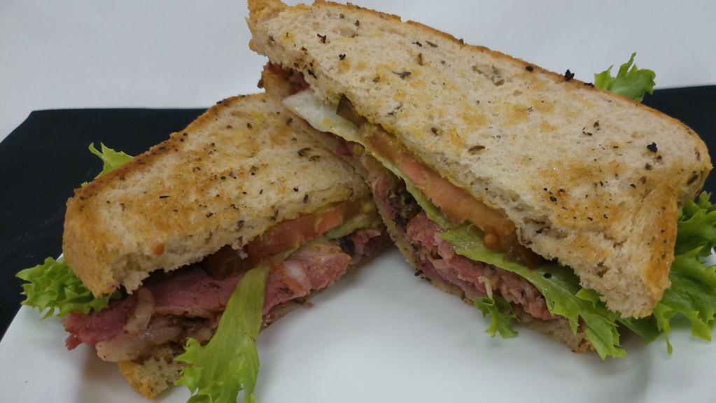Pastrami On Rye · Brined and smoked pastrami served with Swiss, lettuce, heirloom tomato and spicy mustard