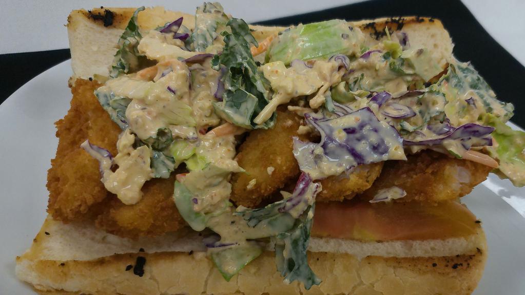 Shrimp Po Boy · Choice of blackened or fried shrimp, Cajun slaw, tomatoes, and our house remoulade on a french roll