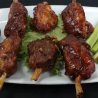 Smoked Pig Wings · Thick cut bone in pork shoulder shanks coated in our very own apple wood rub and slow smoked...