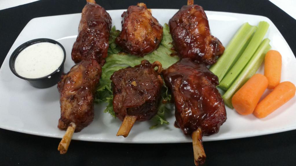 Smoked Pig Wings · Thick cut bone in pork shoulder shanks coated in our very own apple wood rub and slow smoked. Served with green apple slaw and our house BBQ sauce
