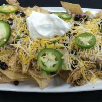 Stacked Nachos · Tortilla chips layered with white queso, corn pico, black beans, shredded jack cheese blend,...