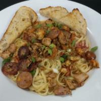 Rajun Cajun Pasta · Blackened smoked chicken, spicy sausage, crawfish, roasted red peppers, onions and tomato bl...