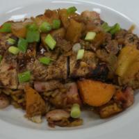 Caribbean Jerk Chicken · Hand rubbed char grilled chicken, pork belly fried rice, charred pineapple salsa, house made...