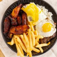 Bistec A Lo Pobre · Tender steak, plantains served over French fries, rice, and fried eggs.