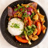 Pollo Saltado · Chicken with onions and tomatoes served over French fries and rice.
