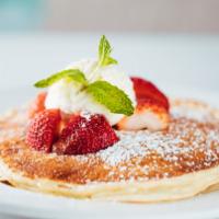 Cloud Cakes · Fluffy ricotta blender pancakes, strawberries, creme fraiche, and powdered sugar.