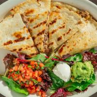 Quesadillas · Soft flour tortilla stuffed with cheese and choice of chicken, steak or shrimp. Served with ...
