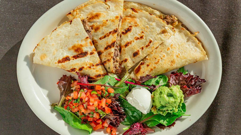 Quesadillas · Soft flour tortilla stuffed with cheese and choice of chicken, steak or shrimp. Served with lettuce, pico de gallo, sour cream, salsa rojo and guacamole.