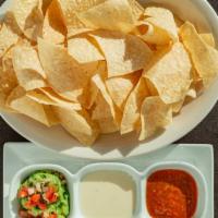 Dip Trio · Fresh fried tortilla chips served with homemade salsa, queso and guacamole.