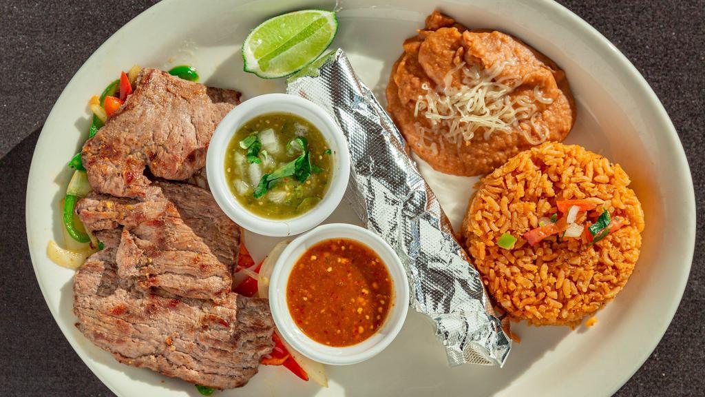 Carne Asada Platter · Juicy grilled carne asada with onions, red and green peppers, guacamole and pico de gallo served with rice and refried beans.