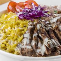 Beef Shawerma Over Rice · Beef , tahini sauce, salad on side