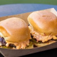 Wagyu Sliders · Two Wagyu beef sliders on brioche rolls served with pimento cheese and pickle.
