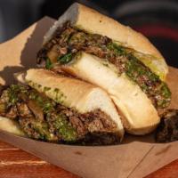 Chimichurri Cheesesteak · Thinly sliced grilled beef with caramelized onions, jalapenos and melted cheddar cheese.