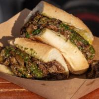 Chimichurri Cheesesteak · Thinly sliced grilled beef with caramelized onions, jalapenos and melted cheddar cheese.
