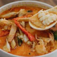 Tom Yum Chicken Soup · Spicy and sour soup with lemongrass, peppers, tomato, onion and mushroom.