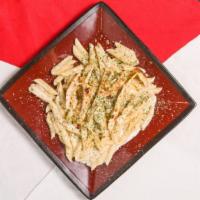 Fettucine Alfredo · White cream sauce topped with grilled chicken.