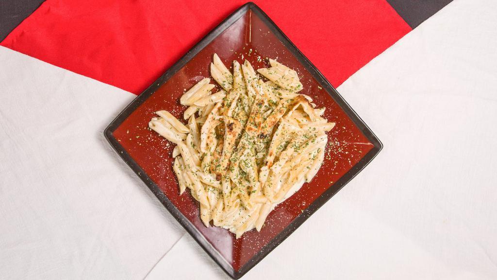 Fettucine Alfredo · White cream sauce topped with grilled chicken.