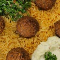 Falafel Bowl · On a bed of yellow rice or spicy red rice, topped with hummus or baba ghonouj, and tabouli s...