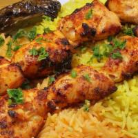 Chicken Kabob Plate · 2 skewers on a bed of yellow and red rice. Includes char-grilled tomato and onion, hummus, h...