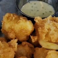 Wisconsin Cheese Curds · House battered Wisconsin cheddar served with ranch.
