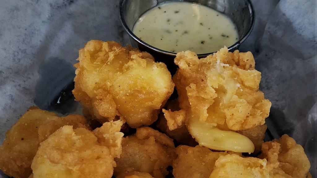 Wisconsin Cheese Curds · House battered Wisconsin cheddar served with ranch.