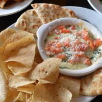Spin Dip · Creamy blend of spinach, artichoke hearts, melted Parmesan and provolone cheese. Served with...
