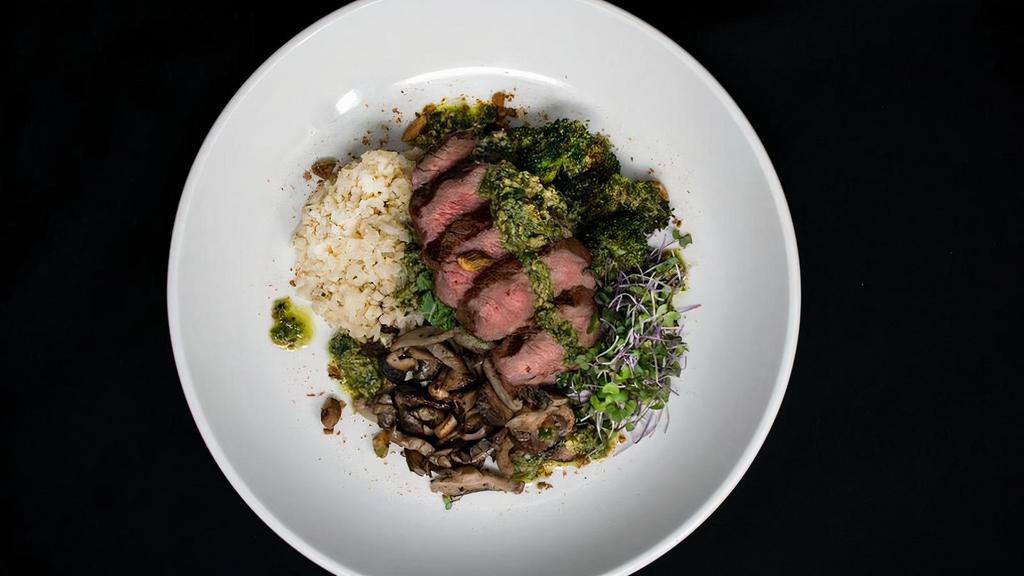 Keto Bowl · Wood-grilled Angus beef Sirloin served over a hearty mix of cauliflower “rice”, garlic-roasted broccoli, wild mushrooms, house-made basil pesto, fresh kale and toasted pistachios.   GF