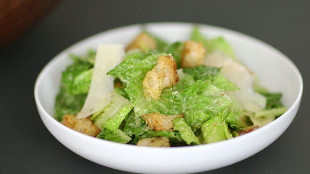 Caesar Salad · Hearts of romaine and croutons, tossed in our traditional creamy dressing and sprinkled with Parmesan cheese.