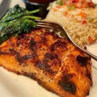 Ancho Salmon · 6 oz fillet of fresh grilled salmon basted with sweet and spicy ancho-honey glaze. Served wi...