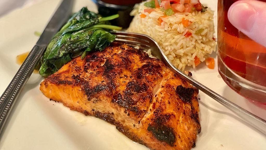 Ancho Salmon · 6 oz fillet of fresh grilled salmon basted with sweet and spicy ancho-honey glaze. Served with sautéed spinach and white rice.