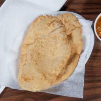 Channa Bhatura · Puffed bread served with spicy chickpeas.