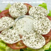 Caprese Salad · Sliced fresh mozzarella cheese over a bed of fresh tomatoes & lettuce Served with balsamic v...