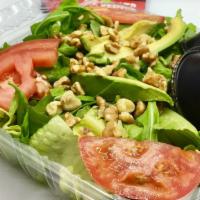 Arugula Salad · Baby arugula mixed with lettuce, tomatoes, sliced avocado, and walnuts Served with balsamic ...