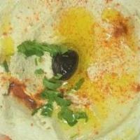 Hummus · Mashed chickpeas seasoned with tahini, garlic, herbs, olive oil and lemon dressing