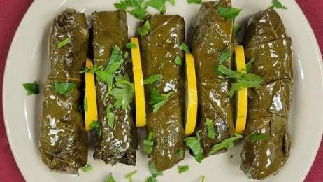 Stuffed Grape Leaves (5) · Grape leaves stuffed with rice and vegetables prepared with olive oil