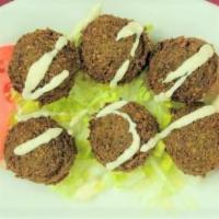 Falafel (6 Pieces) · Ground chickpeas blended with fresh onions and parsley, served with tahini sauce which conta...