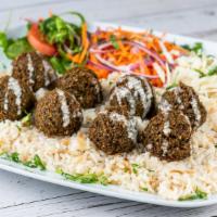 Falafel Platter · Ground chickpeas blended with fresh onions and parsley, served with tahini sauce which conta...