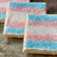 Trans Pride Brown Sugar Shortbread Cookie · Old-fashioned brown sugar shortbread cookies decorated with crystal sugar trans pride flags.