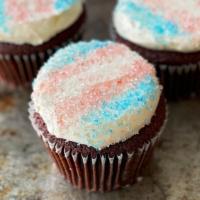 Trans Pride Cupcake · Our Red Velvet Cupcake finished with cream cheese buttercream, topped with crystal sugar tra...
