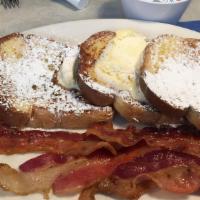 Texas French Toast Deluxe · With bacon, ham and sausages served with butter and syrup.